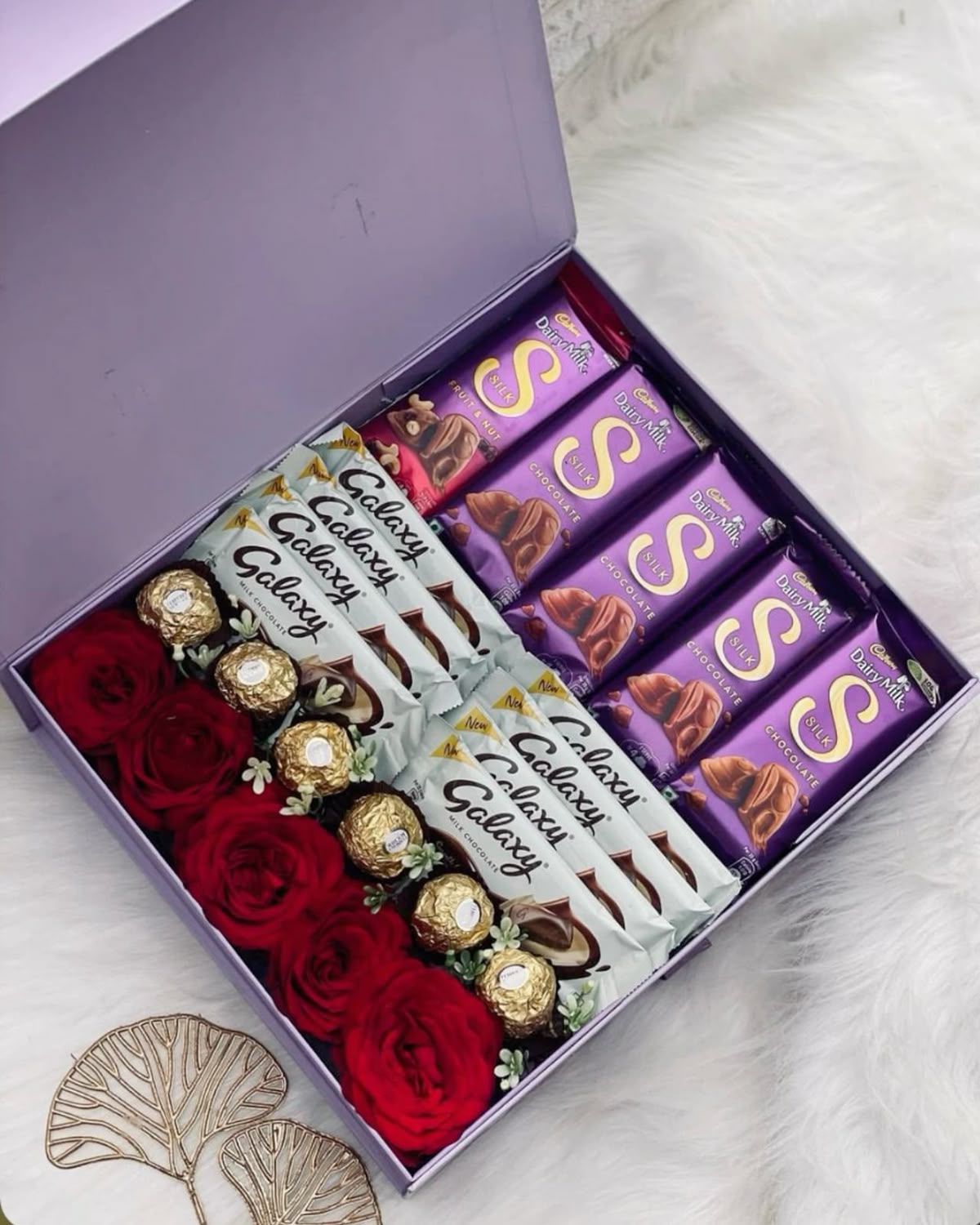 Elegant purple gift box with red roses and chocolates