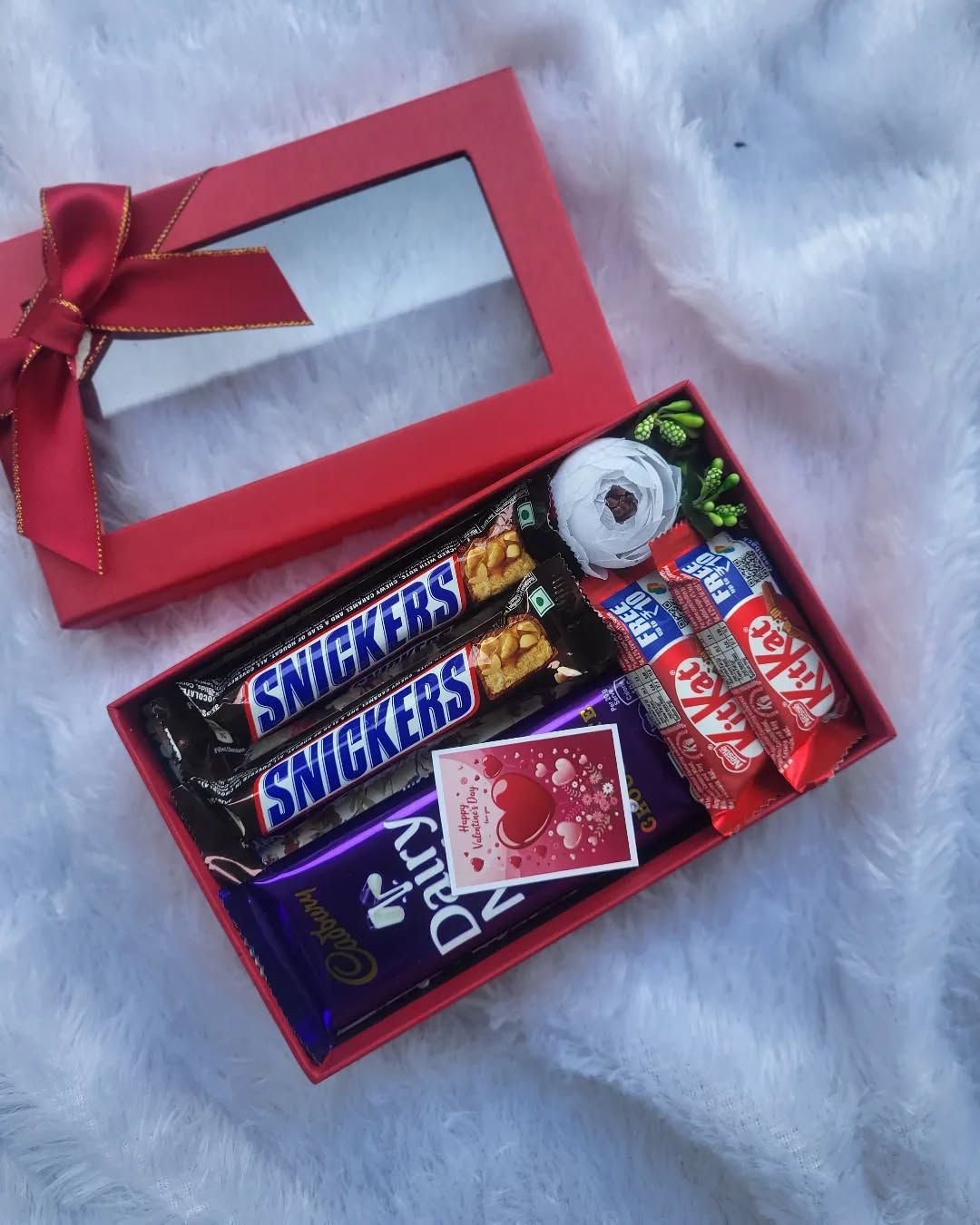 Small red gift box with assorted chocolates and a Valentine's note