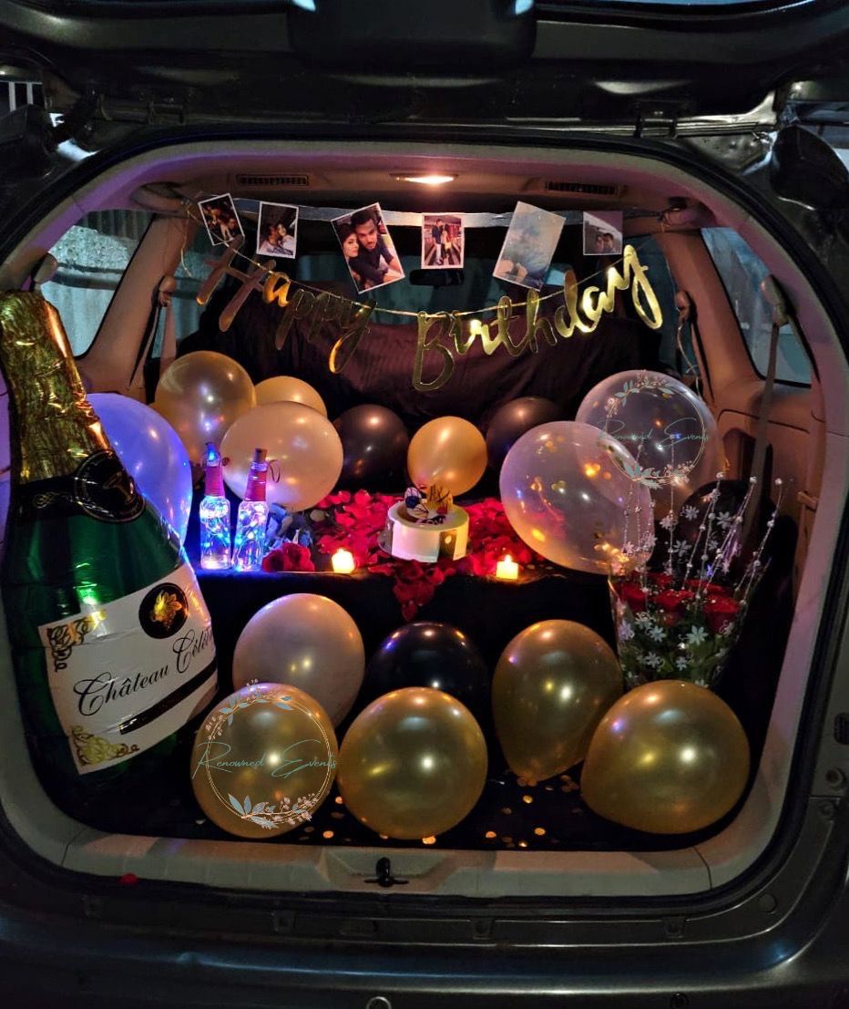 Car trunk surprise with champagne balloon and gold accents