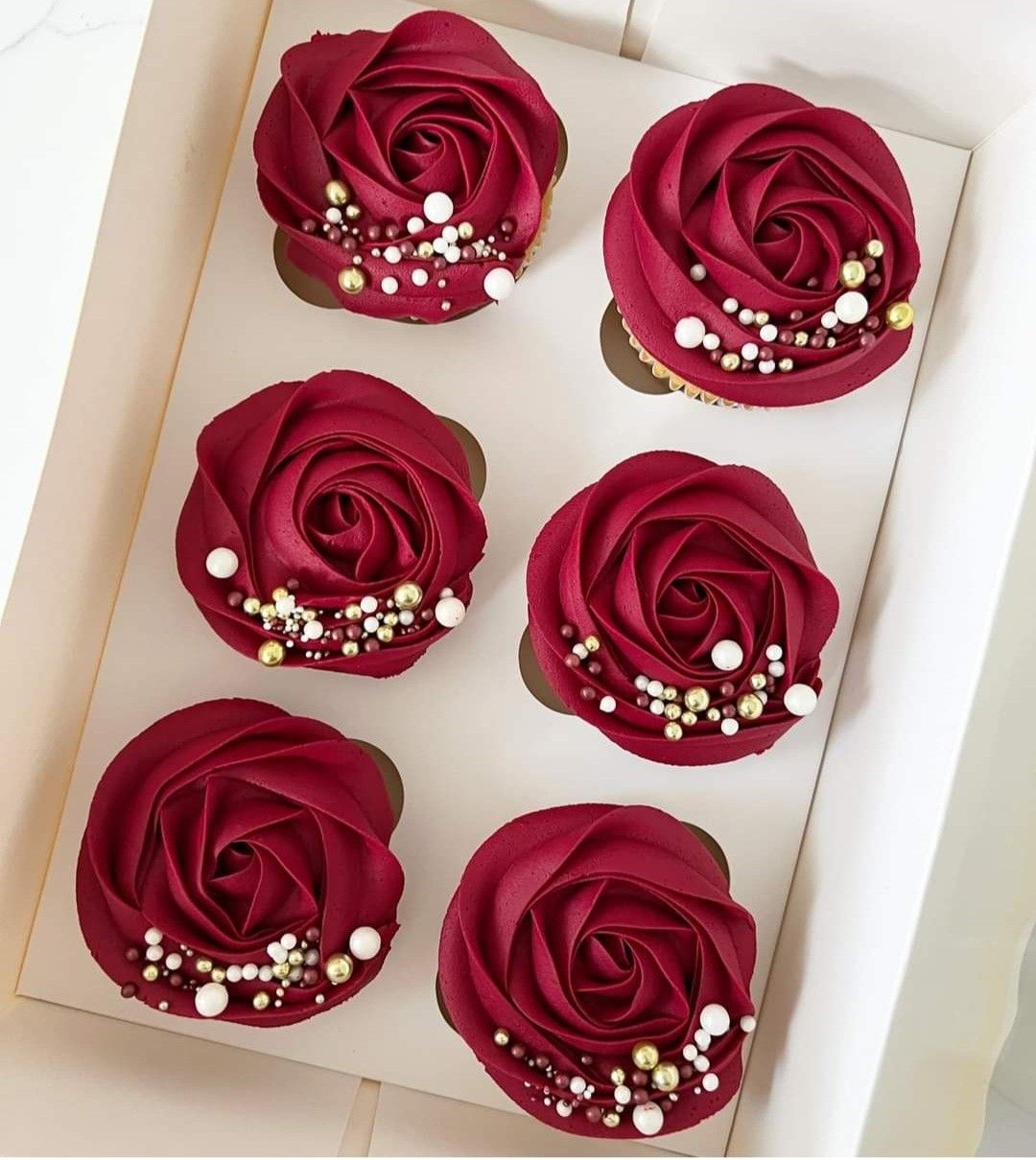 Red rose frosted cupcakes with gold and white sprinkles