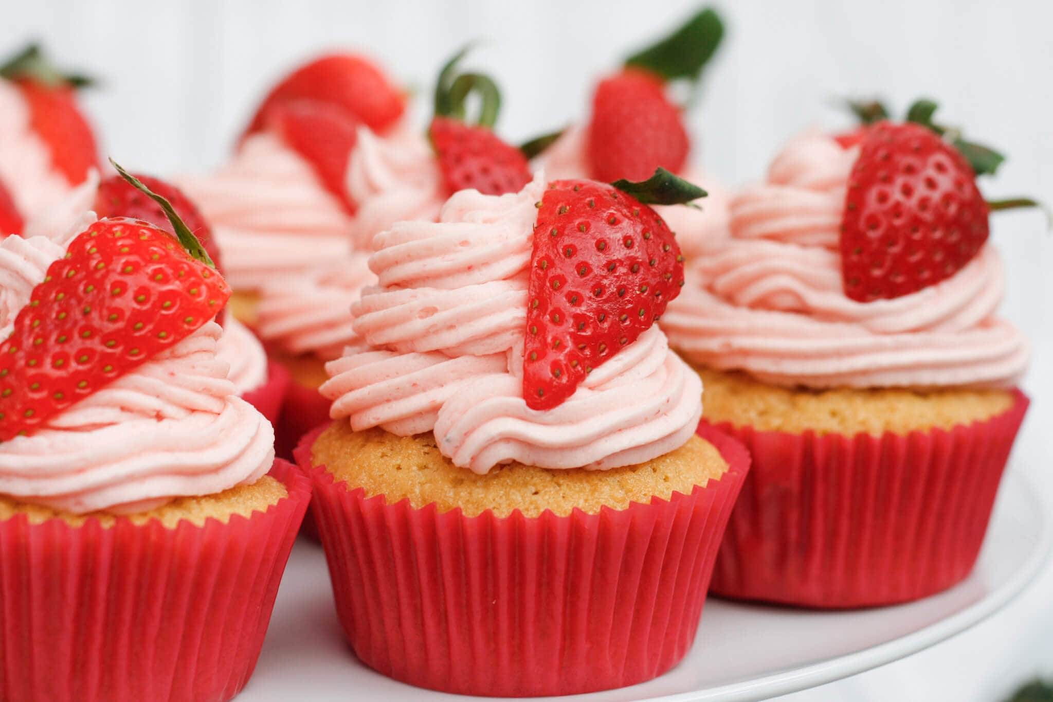 Strawberry cupcakes topped with fresh strawberries
